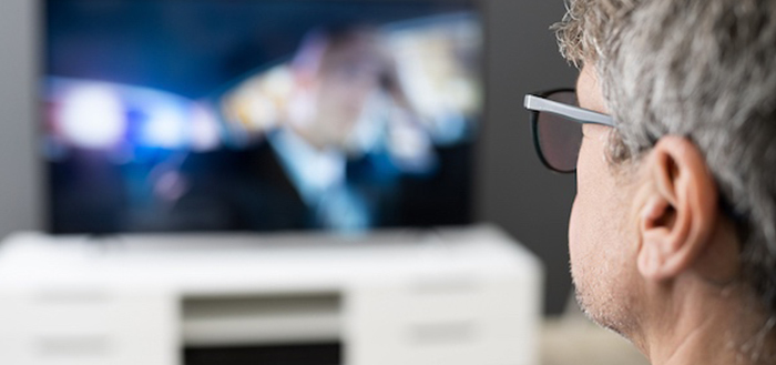 A person watches a mesothelioma commercial while thinking of their loved ones.